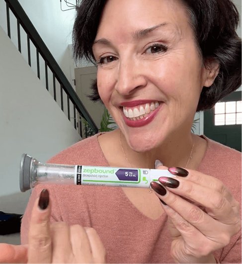 A smiling patient holds a GLP-1 pen injector prescribed by her physician