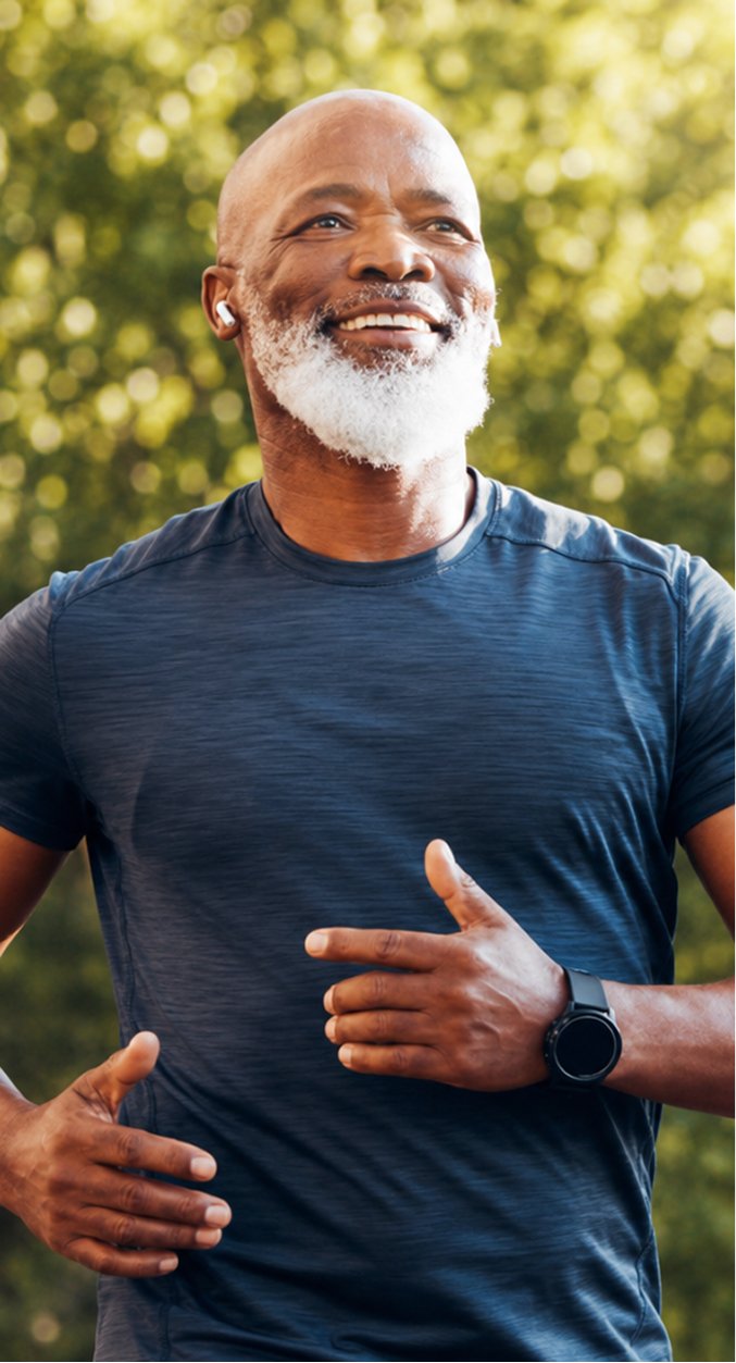 A man smiling outdoors after reaching his medical weight loss goals