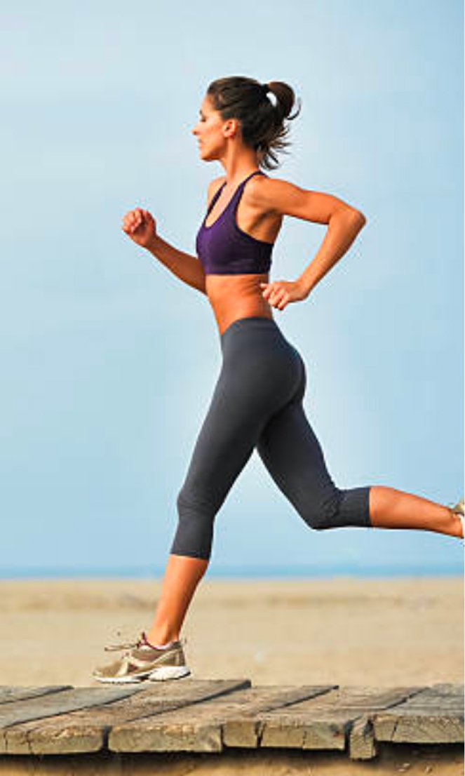 A woman running along a boardwalk after medical weight loss treatment