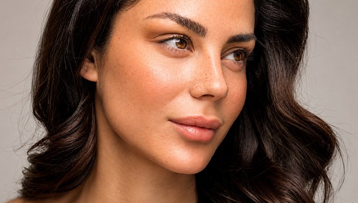 A patient looking over her shoulder with smooth, even skin tone