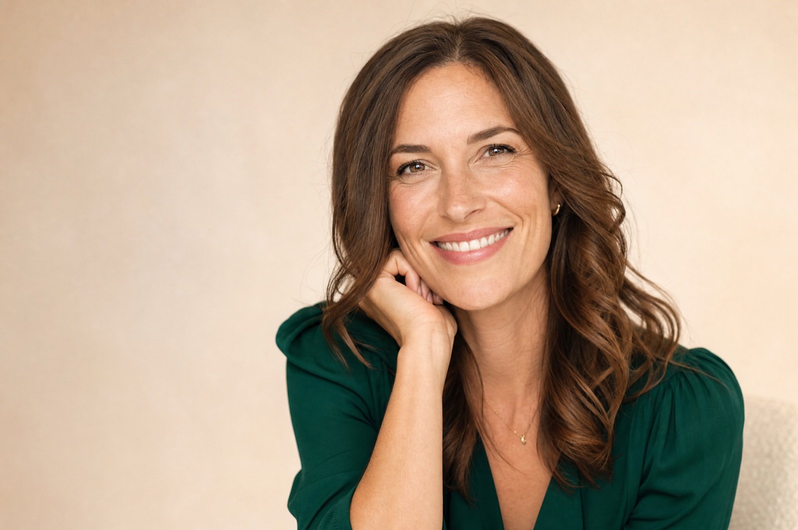 A woman smiling during a women's health visit at GENEVA Med